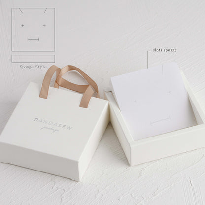 White paper box with champagne ribbon