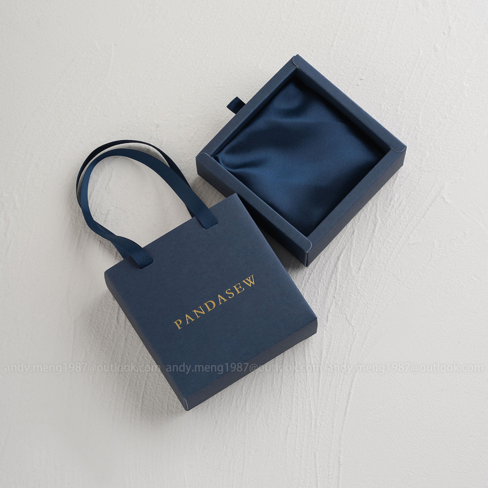 Navy blue jewelry paper box with satin sponge inside